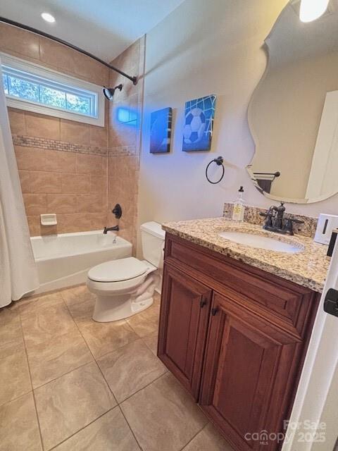 full bathroom featuring toilet, vanity, tile patterned flooring, and shower / tub combo with curtain