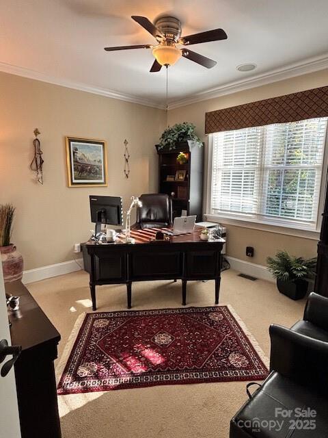 office with ceiling fan, carpet flooring, a healthy amount of sunlight, and ornamental molding