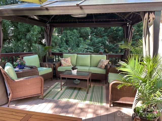 deck with an outdoor hangout area and a gazebo