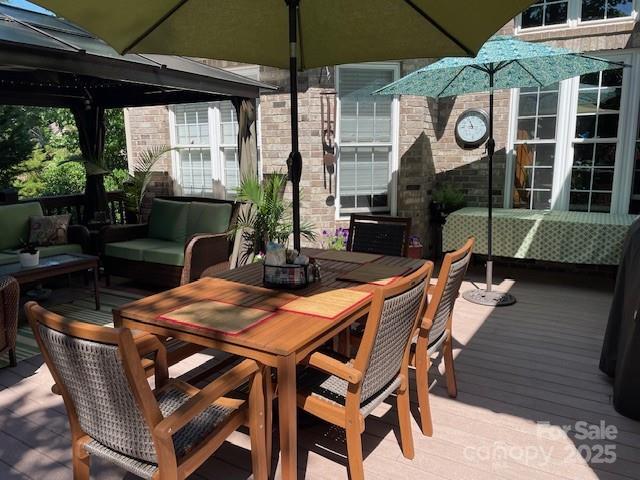 deck featuring a gazebo and outdoor lounge area