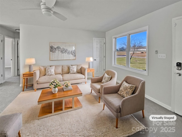 living room featuring ceiling fan and carpet