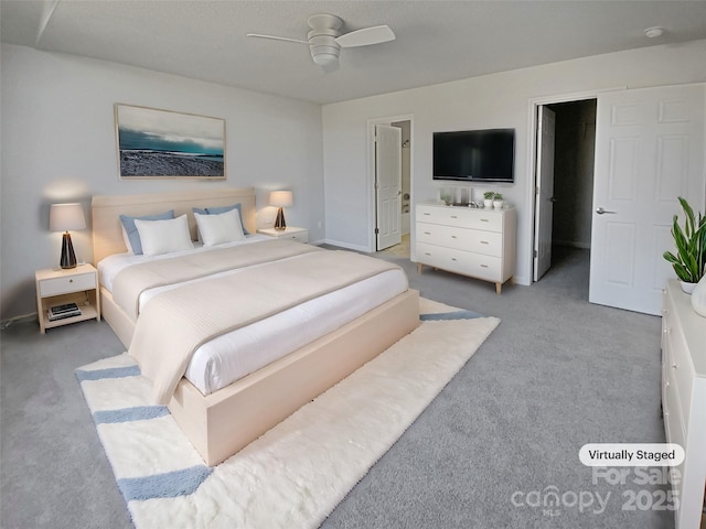 carpeted bedroom featuring ceiling fan and ensuite bathroom