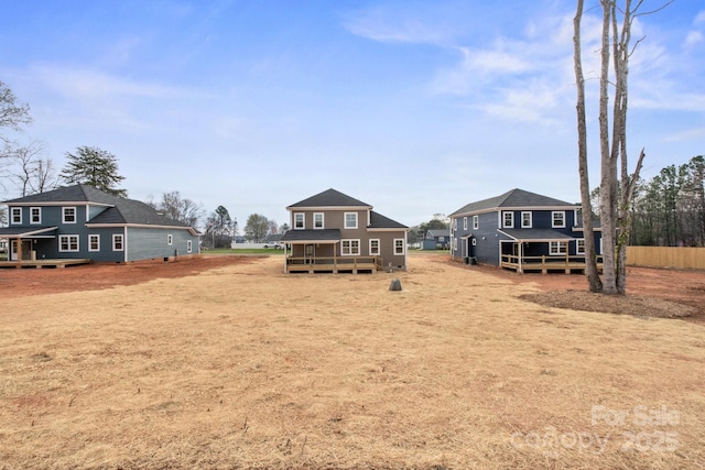 rear view of property featuring a deck