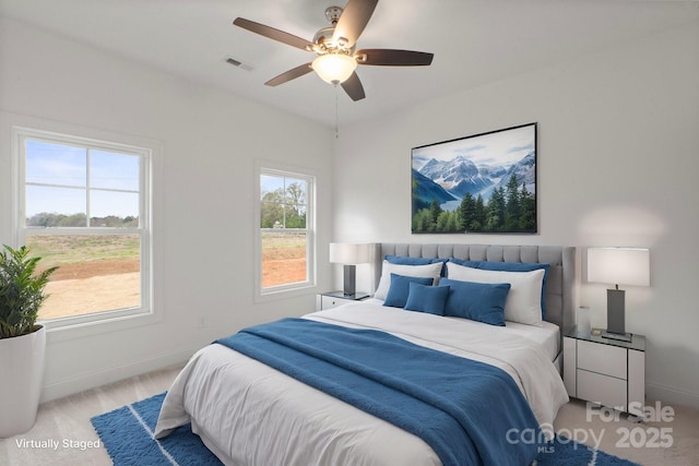 bedroom featuring baseboards, a ceiling fan, carpet flooring, and visible vents