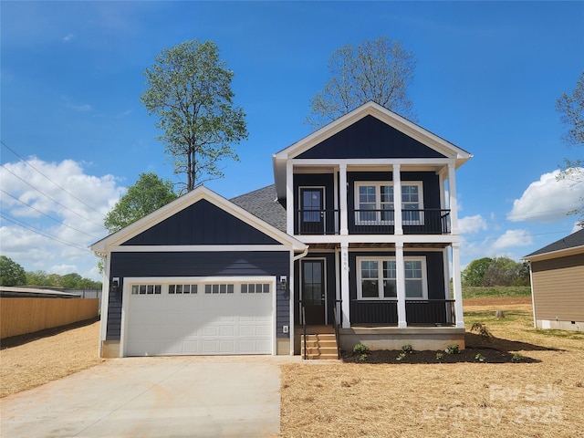 traditional-style home featuring a balcony, board and batten siding, an attached garage, driveway, and covered porch