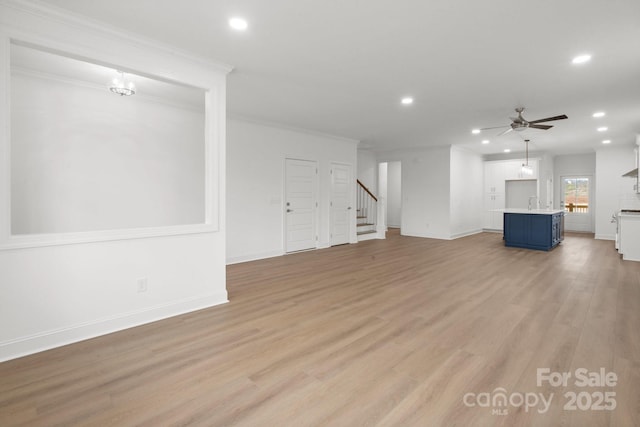 8078 Blackwood Rd, Denver, NC 28037 - unfurnished living room featuring recessed lighting, ornamental molding, stairs, light wood-type flooring, and baseboards