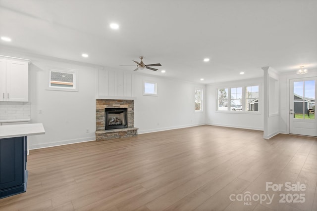 8078 Blackwood Rd, Denver, NC 28037 - unfurnished living room with recessed lighting, a ceiling fan, light wood finished floors, baseboards, and a stone fireplace