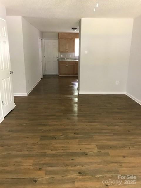 unfurnished room featuring dark wood-type flooring