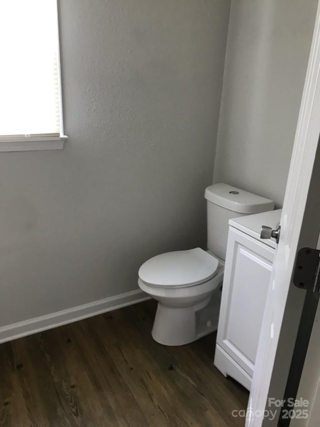 bathroom with toilet, wood-type flooring, and vanity