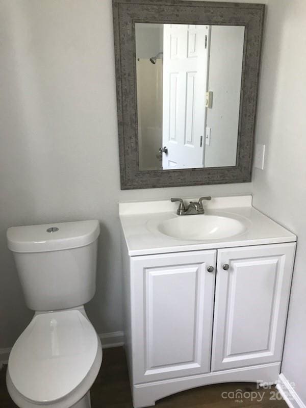 bathroom featuring toilet and vanity