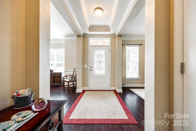 entrance foyer with dark hardwood / wood-style flooring, crown molding, and plenty of natural light