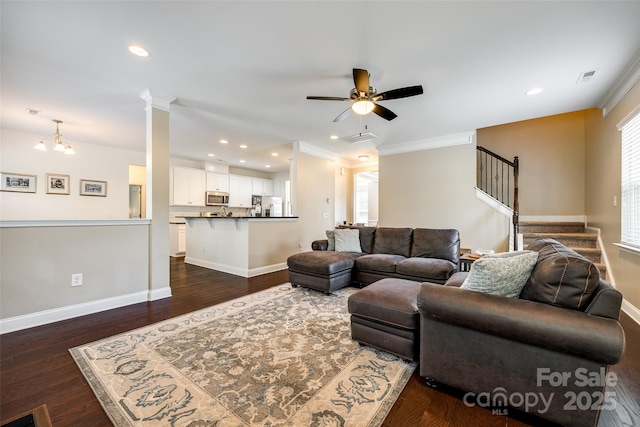 living room with ornate columns, ceiling fan, dark hardwood / wood-style flooring, and crown molding