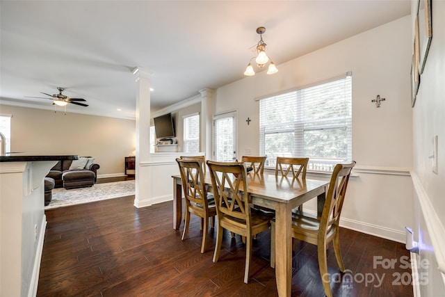 dining area featuring dark hardwood / wood-style flooring, ceiling fan, sink, decorative columns, and crown molding