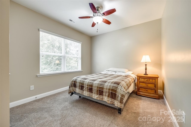 bedroom featuring light carpet and ceiling fan