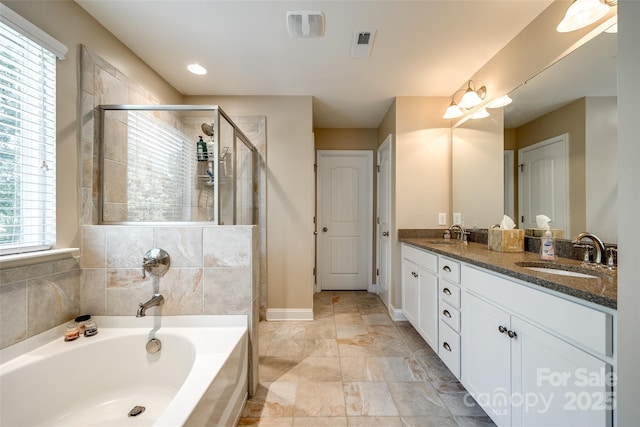 bathroom with separate shower and tub, vanity, and plenty of natural light