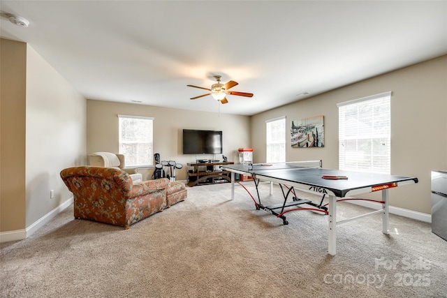 recreation room featuring light carpet and ceiling fan