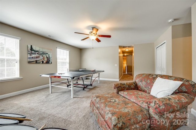 game room featuring light carpet and ceiling fan