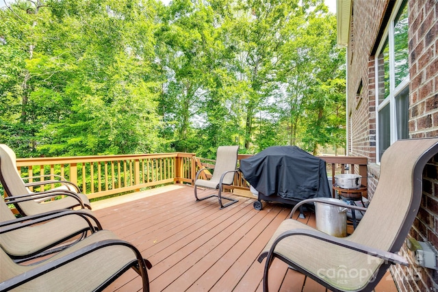 wooden deck with a grill