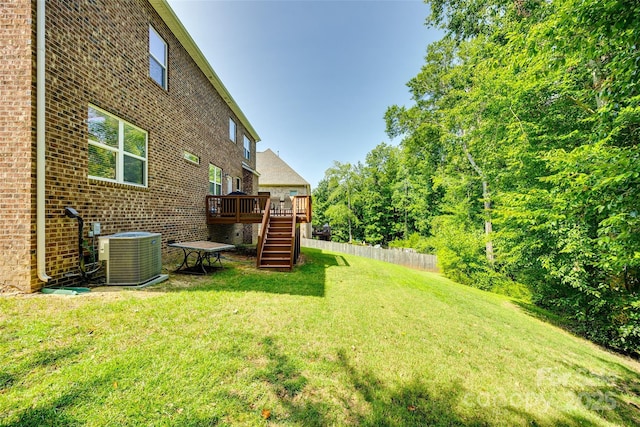 view of yard featuring central AC unit and a deck