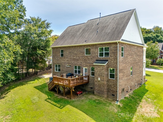 rear view of property with a deck and a yard