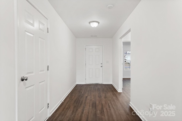 corridor with dark hardwood / wood-style floors