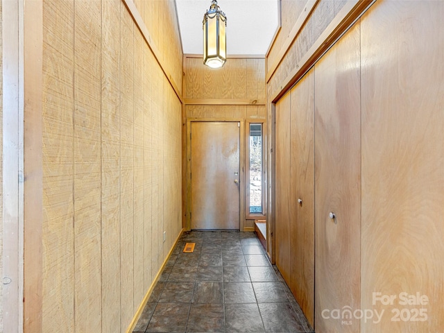 doorway featuring wood walls