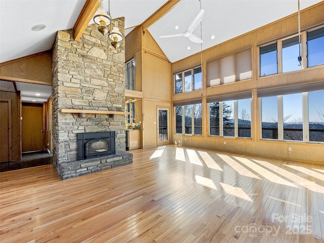 unfurnished living room featuring hardwood / wood-style floors, high vaulted ceiling, and beamed ceiling