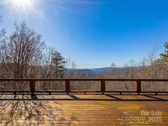 wooden deck with a mountain view