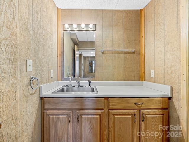 bathroom featuring vanity and wood walls