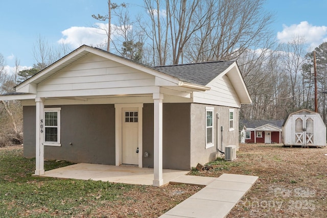 exterior space featuring a storage unit, a patio area, and central air condition unit