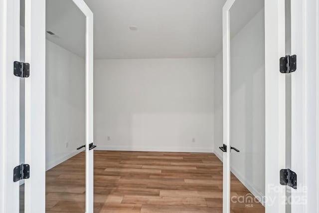604 Hyder Trl, Tega Cay, SC 29708 - laundry area featuring wood finished floors, baseboards, and french doors