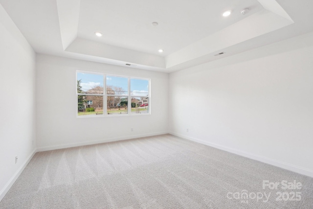 604 Hyder Trl, Tega Cay, SC 29708 - unfurnished room featuring a raised ceiling, recessed lighting, light colored carpet, baseboards, and a smoke detector