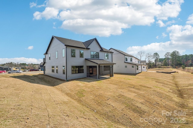 604 Hyder Trl, Tega Cay, SC 29708 - rear view of house featuring a sunroom and a lawn