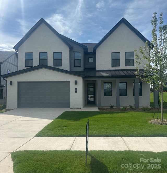 604 Hyder Trl, Tega Cay, SC 29708 - view of front facade featuring a standing seam roof, a garage, driveway, a front yard, and a metal roof