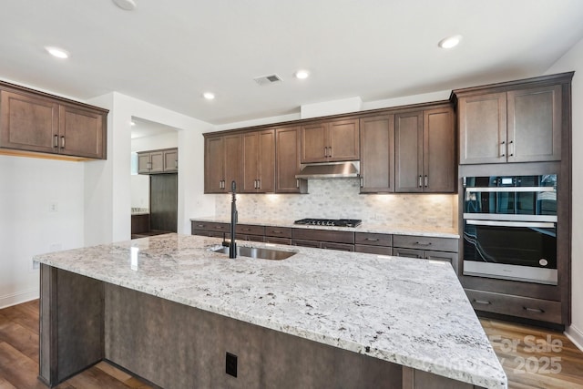 604 Hyder Trl, Tega Cay, SC 29708 - kitchen featuring under cabinet range hood, stainless steel appliances, dark wood-style flooring, light stone countertops, and recessed lighting