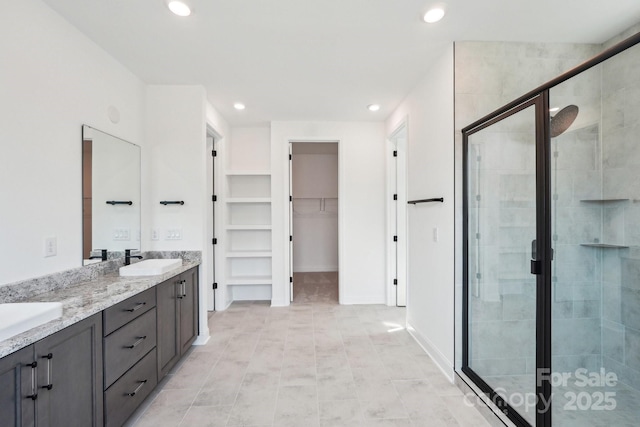 604 Hyder Trl, Tega Cay, SC 29708 - full bathroom featuring a stall shower, double vanity, a walk in closet, and recessed lighting