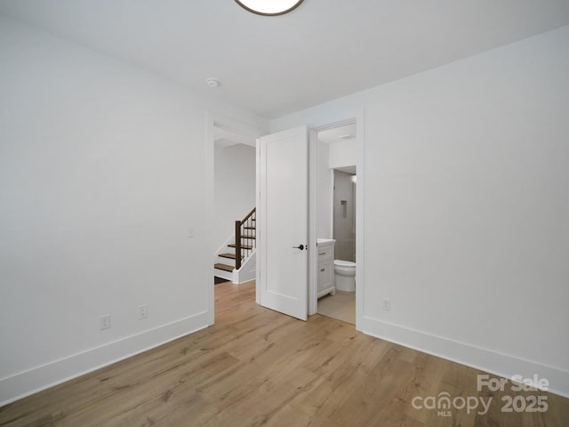 2530 Weddington Ave Unit 12, Charlotte, NC 28204 - unfurnished bedroom with baseboards, light wood finished floors, and ensuite bath