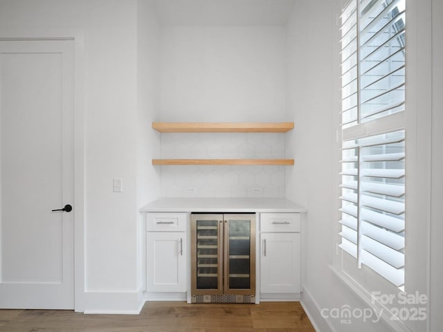 2530 Weddington Ave Unit 12, Charlotte, NC 28204 - indoor dry bar featuring beverage cooler, tasteful backsplash, wood finished floors, and baseboards