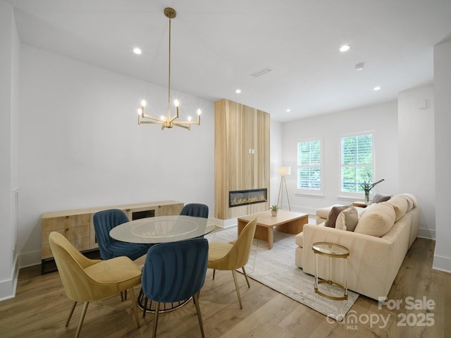 2530 Weddington Ave Unit 12, Charlotte, NC 28204 - dining room featuring light wood-style floors, a large fireplace, a chandelier, baseboards, and recessed lighting