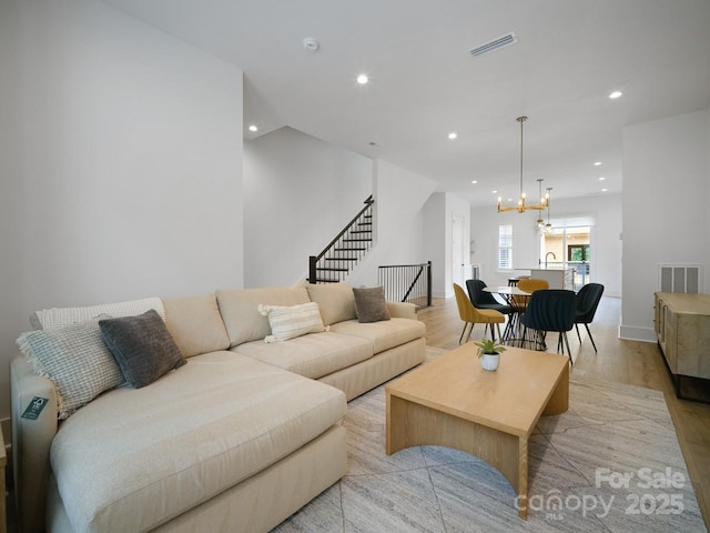 2530 Weddington Ave Unit 12, Charlotte, NC 28204 - living room featuring recessed lighting, light wood-style floors, a chandelier, stairs, and baseboards