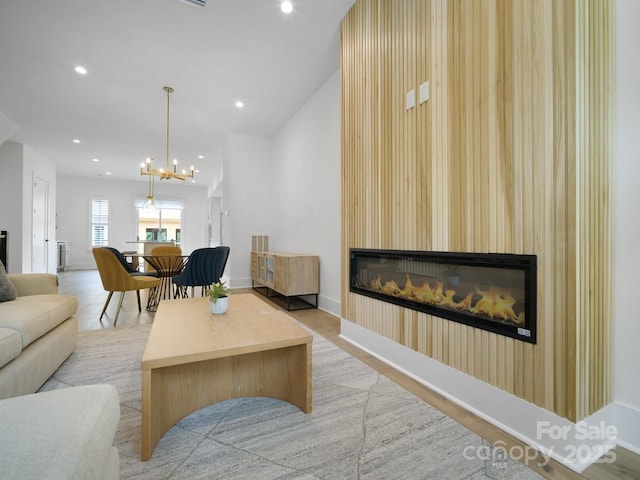 2530 Weddington Ave Unit 12, Charlotte, NC 28204 - living room featuring a glass covered fireplace, recessed lighting, light wood finished floors, a chandelier, and baseboards