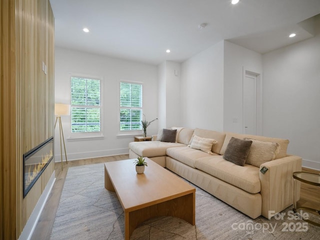 2530 Weddington Ave Unit 12, Charlotte, NC 28204 - living area with light wood finished floors, recessed lighting, a glass covered fireplace, and baseboards