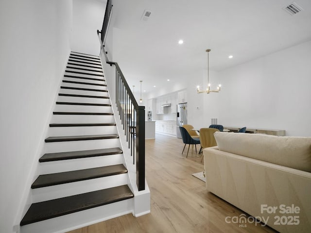 2530 Weddington Ave Unit 12, Charlotte, NC 28204 - stairway featuring wood finished floors, recessed lighting, and a chandelier