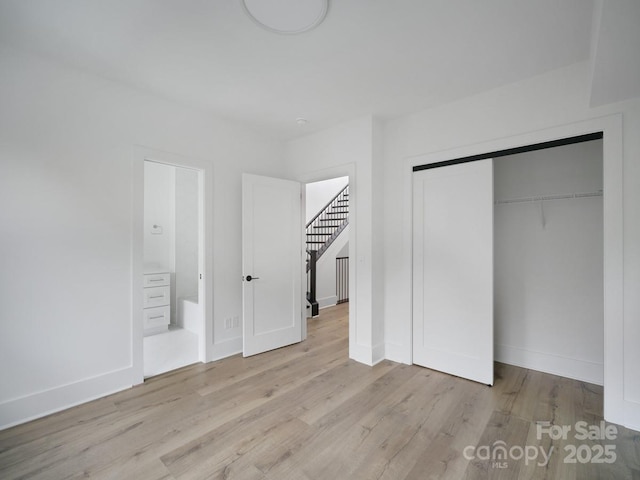 2530 Weddington Ave Unit 12, Charlotte, NC 28204 - unfurnished bedroom featuring wood finished floors, baseboards, a closet, and ensuite bath