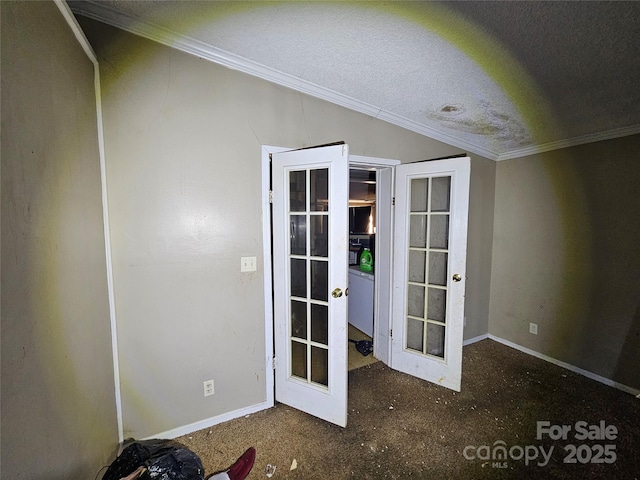 doorway to outside with a textured ceiling, crown molding, and french doors