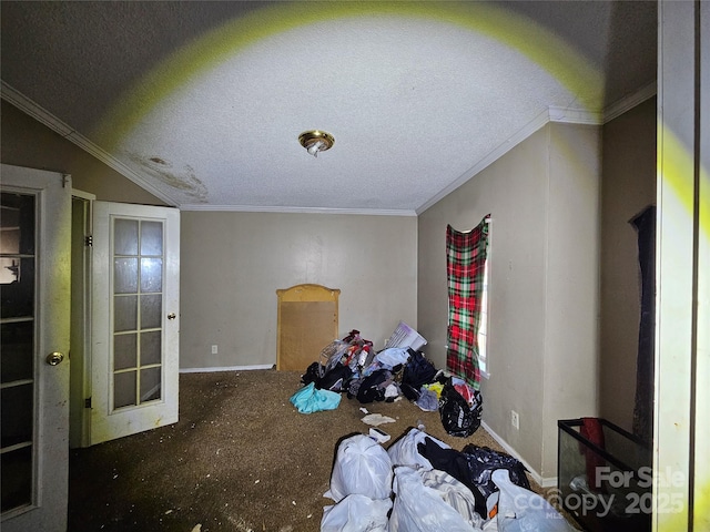 interior space with vaulted ceiling, a textured ceiling, and ornamental molding