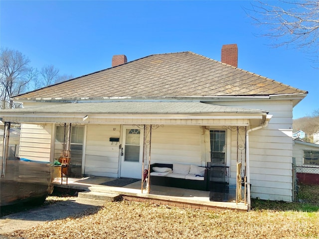 rear view of property with a porch