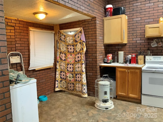 kitchen featuring brick wall, washer / dryer, and white electric range oven