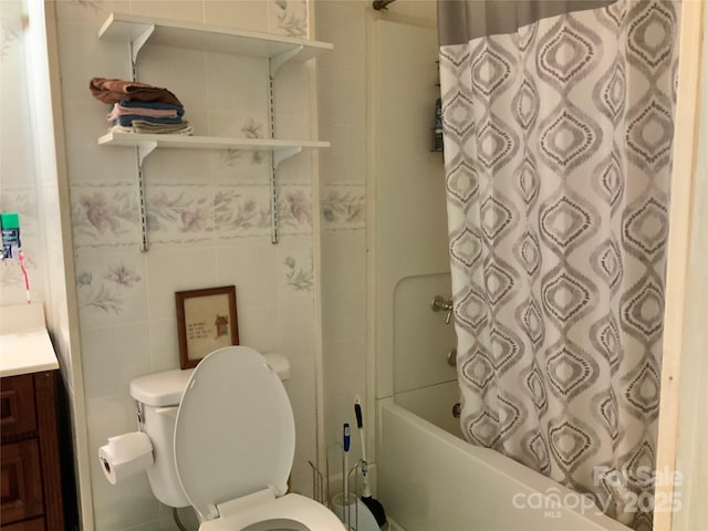 full bathroom with shower / bath combination with curtain, vanity, toilet, and tile walls