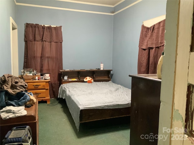 carpeted bedroom with ornamental molding